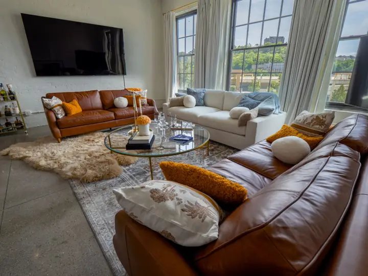 Leather sectional and glass coffee table